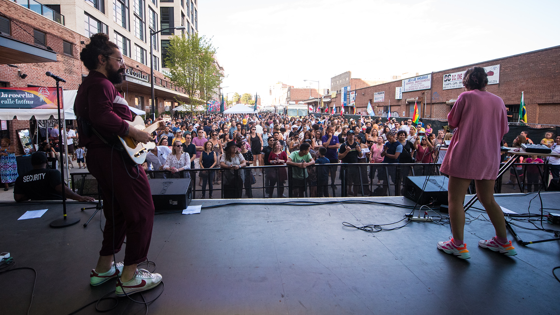 Outdoor community performance with a large audience.
