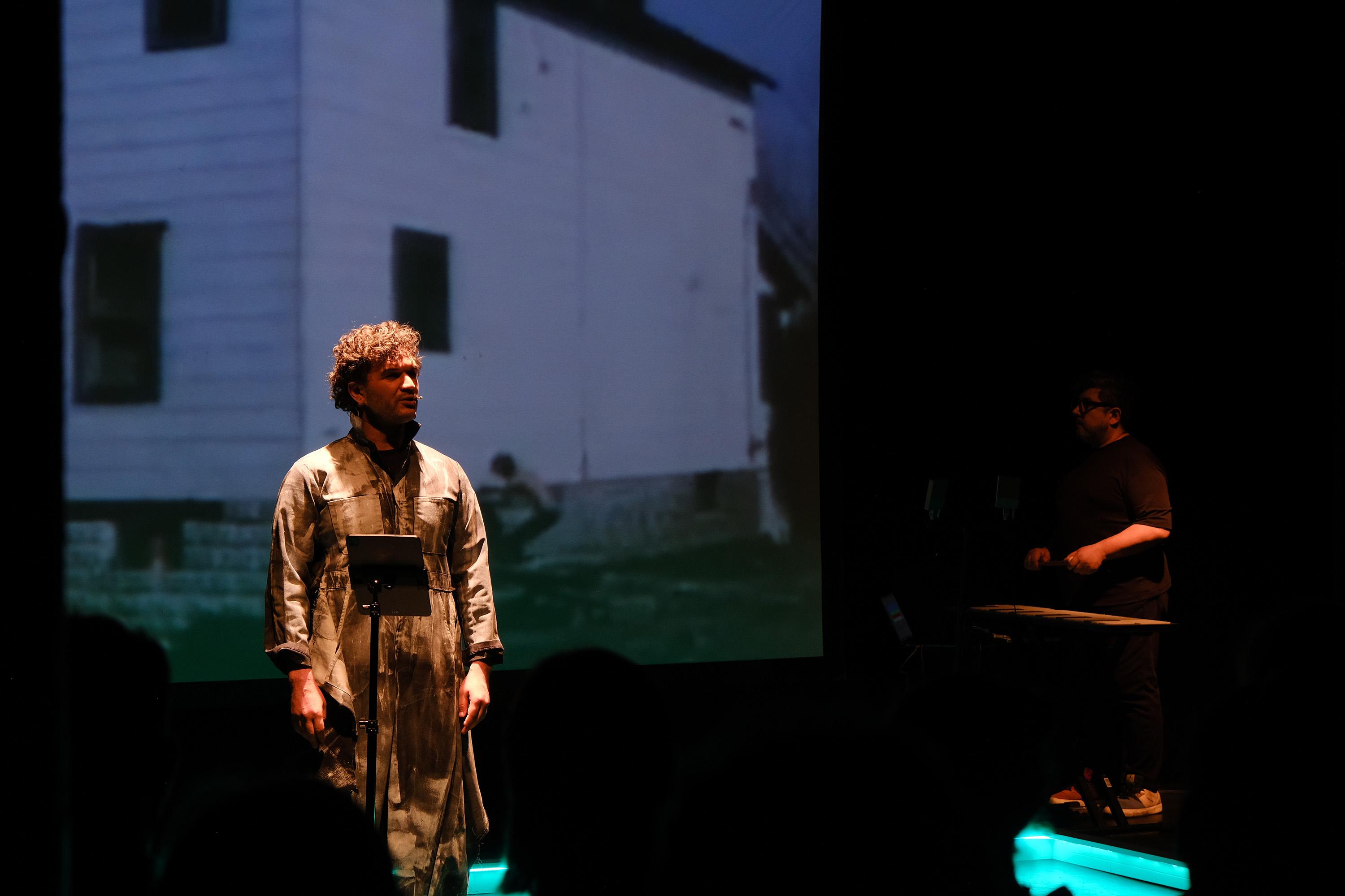 Theater performance with projection and live music.